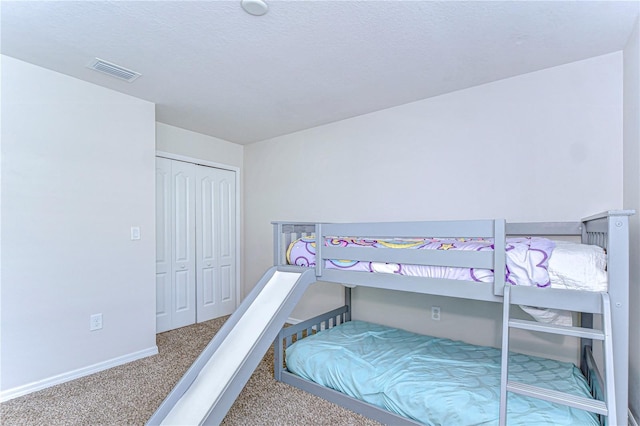 carpeted bedroom with a closet