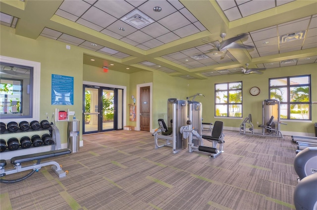 workout area featuring light carpet and french doors