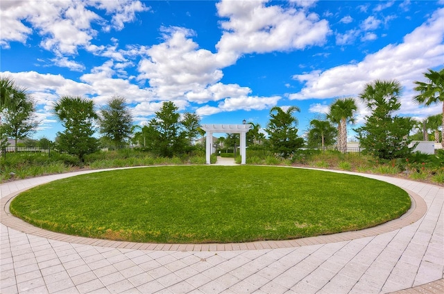 surrounding community with a yard and a pergola