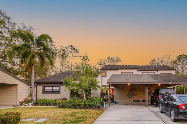 view of front of house with a lawn and a carport