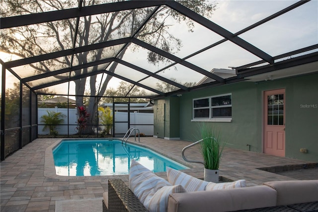 view of pool with a patio, fence, glass enclosure, and a fenced in pool