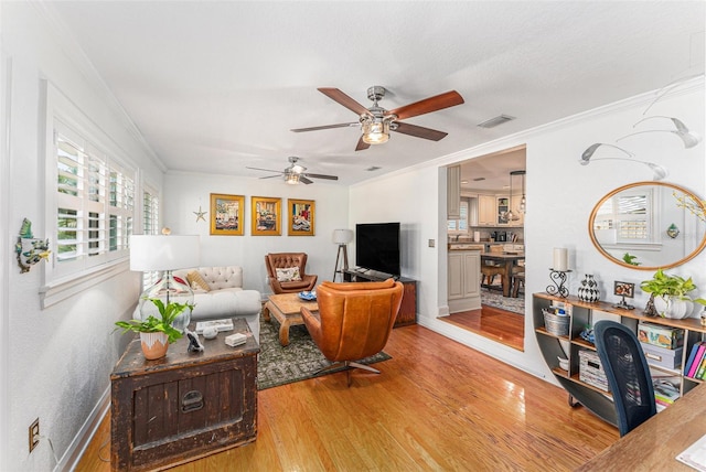 living room with hardwood / wood-style flooring and ornamental molding