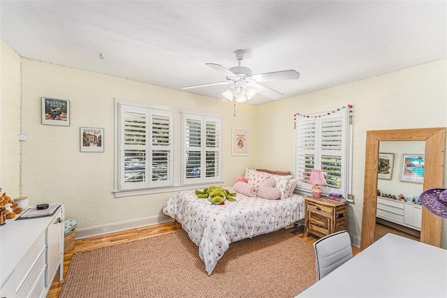 bedroom with wood-type flooring and ceiling fan