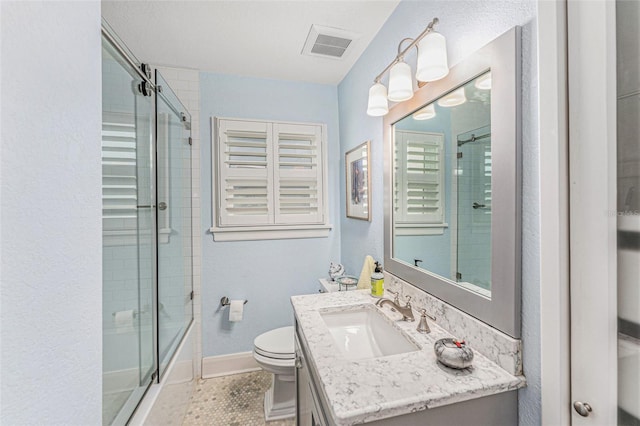 bathroom featuring vanity, tile patterned floors, and toilet