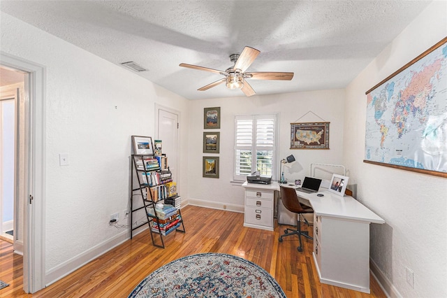 office with ceiling fan, a textured ceiling, and light wood-type flooring