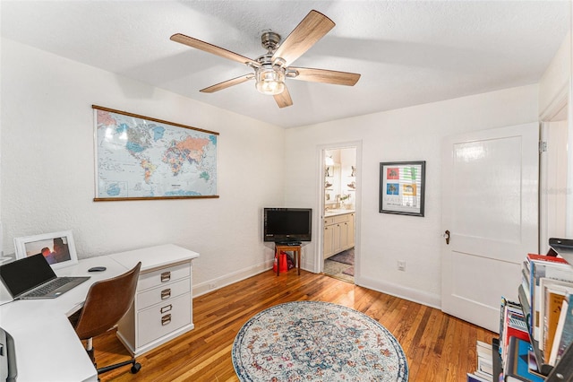 office area with ceiling fan, a textured ceiling, and light wood-type flooring