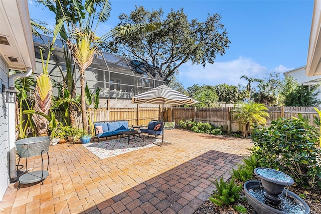 view of patio featuring outdoor lounge area and glass enclosure