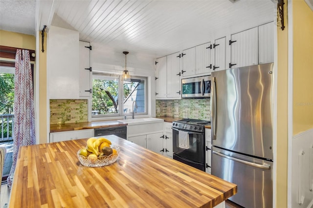 kitchen with butcher block countertops, sink, hanging light fixtures, black appliances, and white cabinets