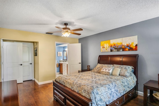 bedroom featuring ceiling fan, dark wood-type flooring, connected bathroom, and a textured ceiling