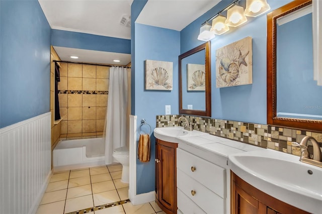 full bathroom featuring tasteful backsplash, shower / bath combination with curtain, tile patterned flooring, vanity, and toilet