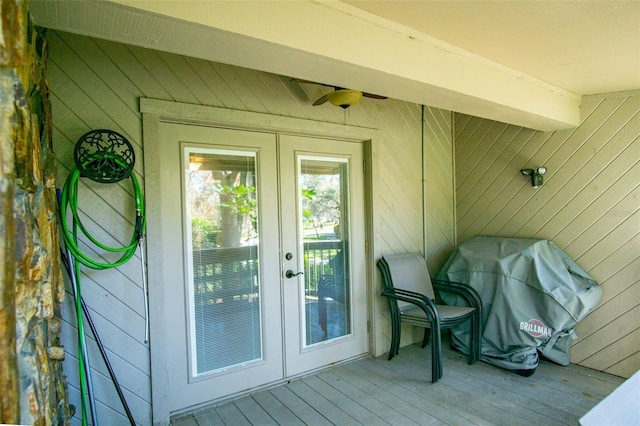 exterior space featuring light hardwood / wood-style flooring, french doors, beamed ceiling, and wood walls