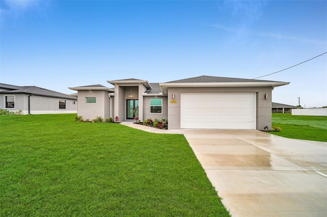 prairie-style house featuring a garage and a front lawn