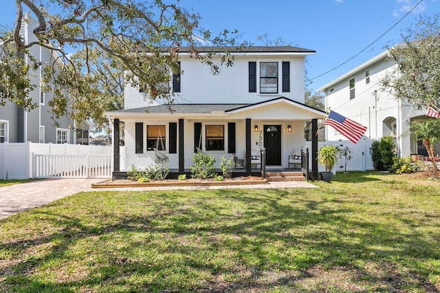 view of front facade with covered porch and a front lawn