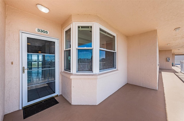 property entrance with stucco siding