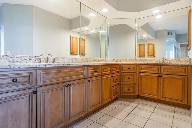 full bath featuring double vanity, tile patterned flooring, a sink, and visible vents