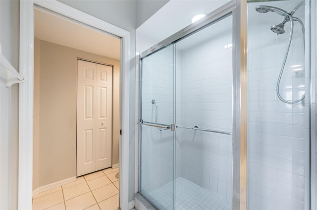 bathroom featuring a stall shower, baseboards, and tile patterned floors