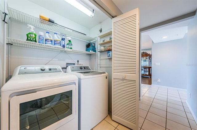 laundry room with light tile patterned floors, laundry area, and washing machine and dryer