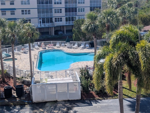 pool with fence and a patio