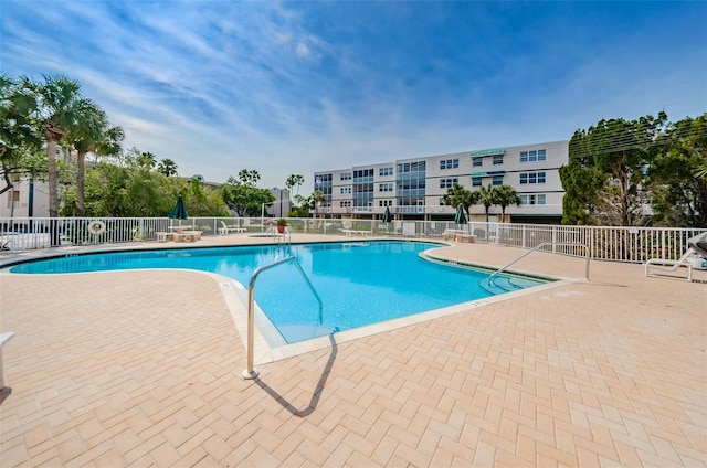 pool featuring a patio and fence