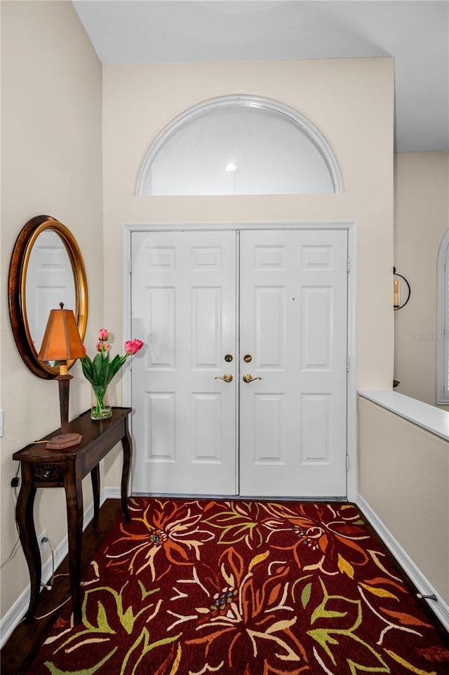 foyer entrance with dark colored carpet