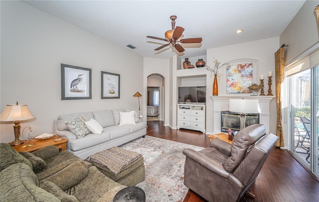 living room featuring dark wood-type flooring and ceiling fan