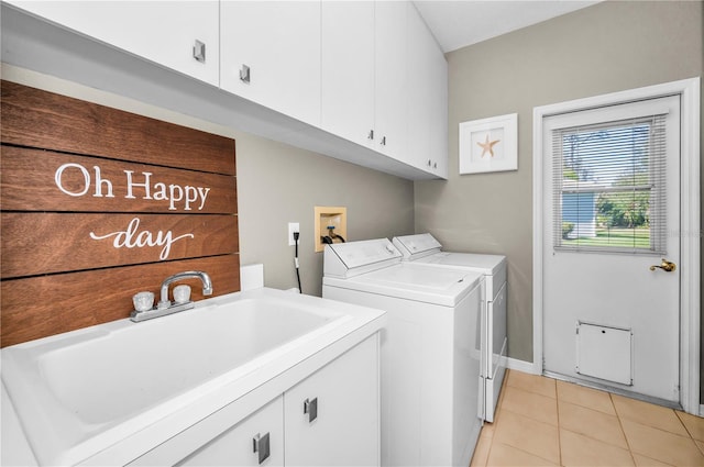 laundry room with cabinets, independent washer and dryer, sink, and light tile patterned floors