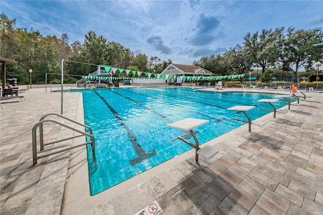 view of pool with a diving board