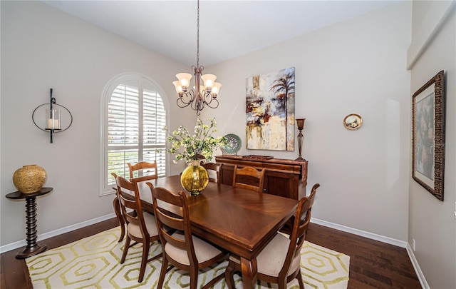 dining room featuring dark hardwood / wood-style floors and an inviting chandelier