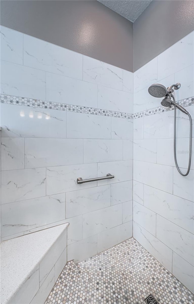 bathroom with a tile shower