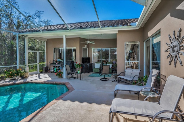 view of pool with ceiling fan, a lanai, and a patio