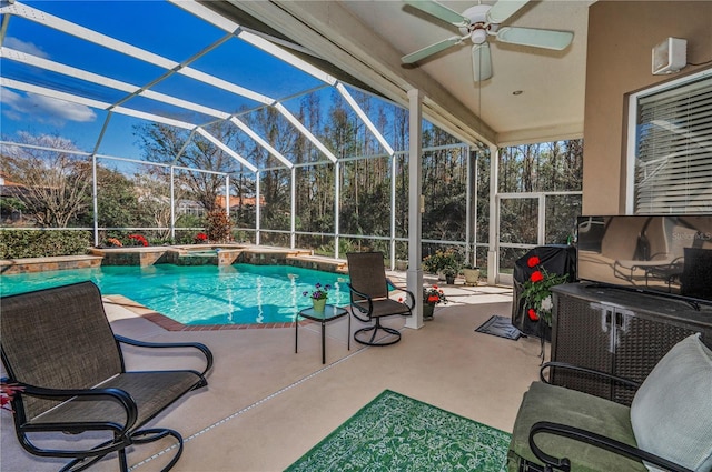 view of swimming pool featuring a patio, ceiling fan, and glass enclosure