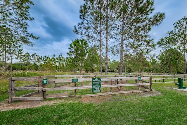 view of property's community with a yard and a rural view