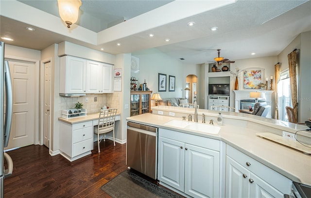 9101 Highland Ridge Way, Tampa, FL 33647 - kitchen featuring a sink, open floor plan, appliances with stainless steel finishes, a fireplace, and dark wood-type flooring