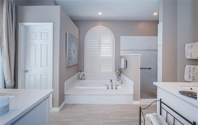 9101 Highland Ridge Way, Tampa, FL 33647 - full bathroom with a walk in shower, vanity, a garden tub, and recessed lighting