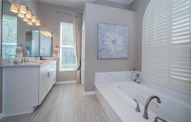 9101 Highland Ridge Way, Tampa, FL 33647 - bathroom with baseboards, vanity, and a garden tub