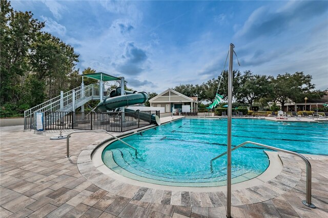 9101 Highland Ridge Way, Tampa, FL 33647 - community pool featuring a patio area, fence, a water slide, and playground community