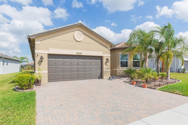 view of front of property featuring a garage and a front lawn