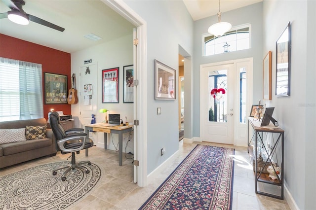 foyer featuring light tile patterned flooring, plenty of natural light, and ceiling fan