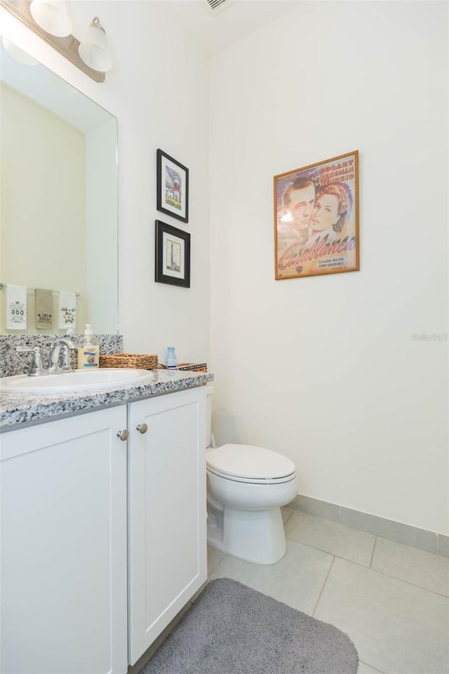 bathroom featuring vanity, toilet, and tile patterned flooring