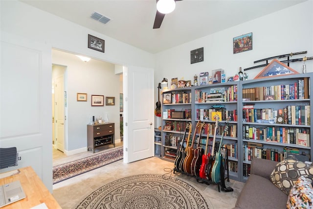 sitting room featuring light tile patterned flooring and ceiling fan