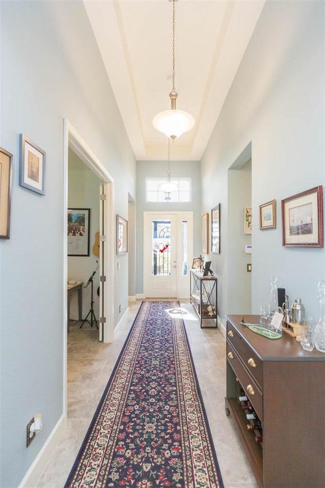 doorway featuring a tray ceiling