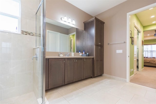 bathroom with vanity, tile patterned flooring, and walk in shower