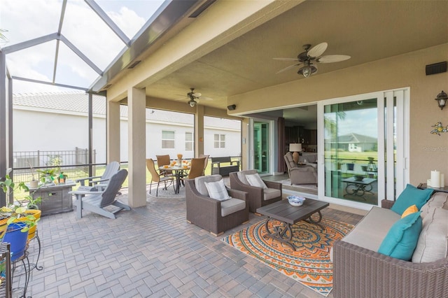 view of patio with a lanai, outdoor lounge area, and ceiling fan