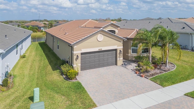 view of front of house with a garage and a front lawn