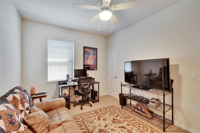 office area with baseboards, a ceiling fan, and light colored carpet