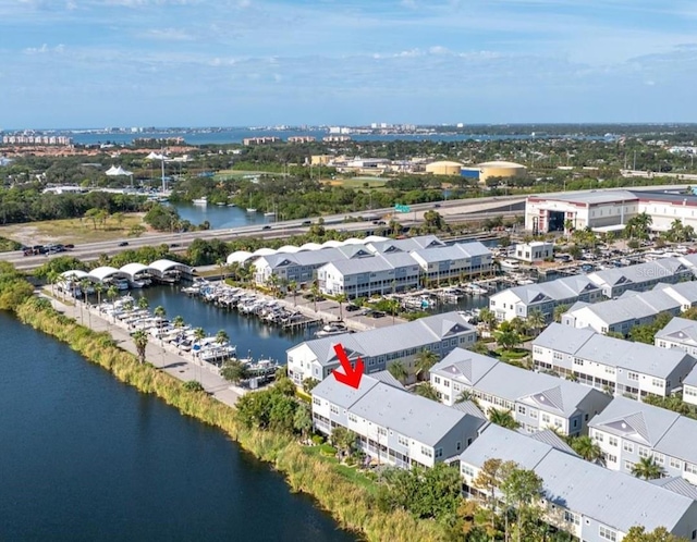 drone / aerial view with a residential view and a water view