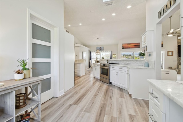 kitchen featuring pendant lighting, white cabinets, stainless steel range with electric cooktop, light hardwood / wood-style floors, and light stone countertops