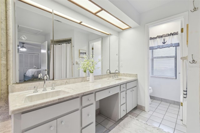 bathroom featuring vanity, toilet, and tile patterned flooring