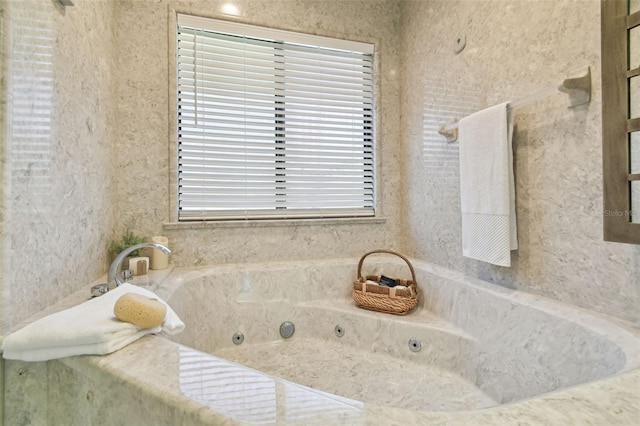 bathroom with a tub to relax in