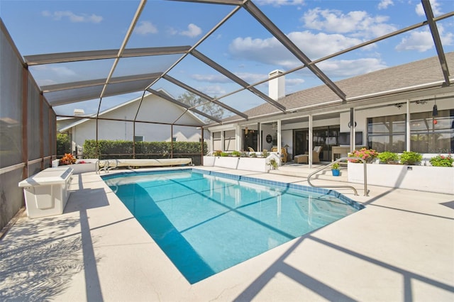 view of pool with a lanai and a patio area